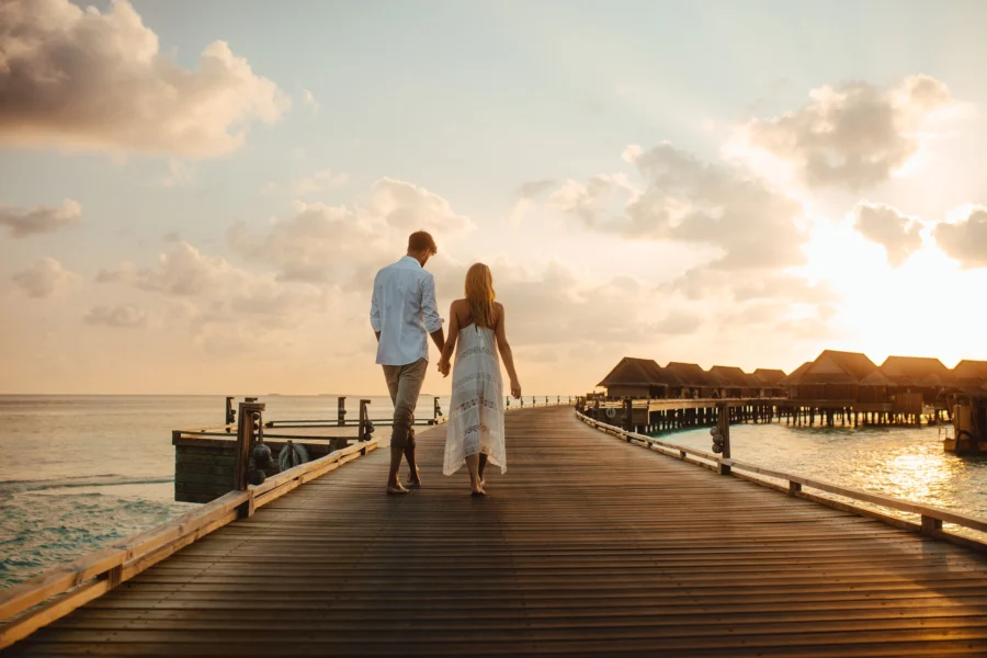 Couple on honeymoon walking in sunset