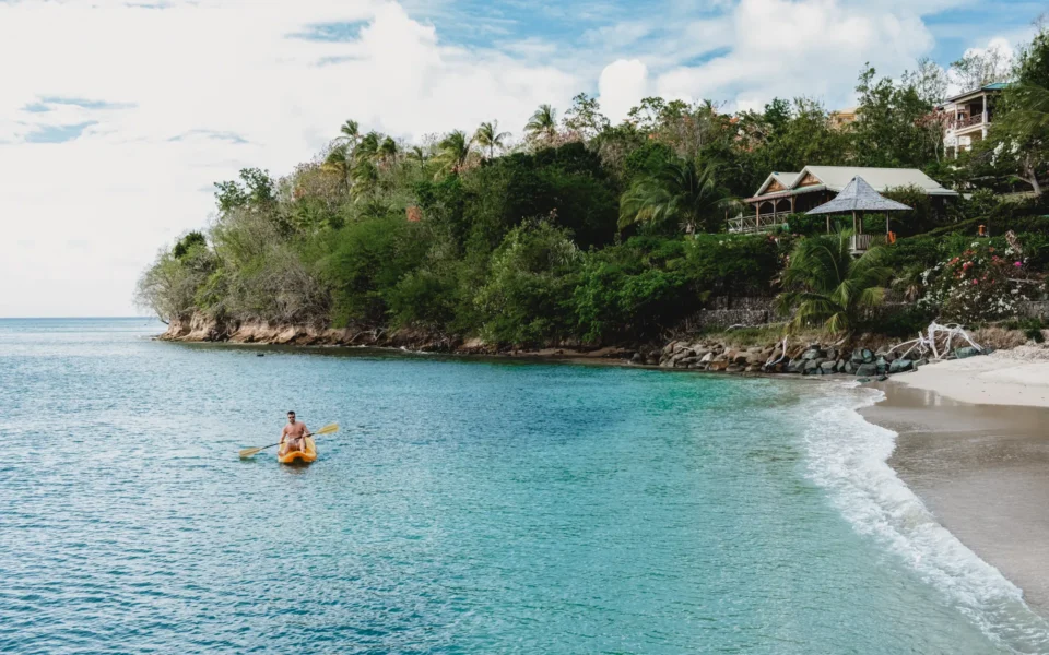 Man on a kayak on clear Saint Vincent waters